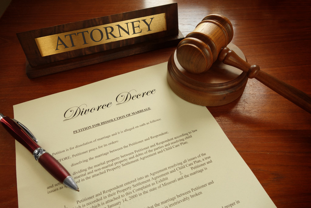 A divorce decree, a gavel, and an attorney nameplate